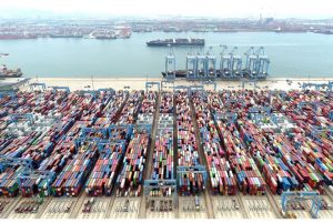 An aerial view shows containers and cargo vessels at the Qingdao port in Shandong province, China May 9, 2022