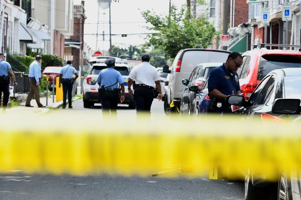 Police officers work at the scene as investigations are ongoing the day after a mass shooting in the Kingsessing section of southwest Philadelphia, Pennsylvania, U.S. July 4, 2023. REUTERS/Bastiaan Slabbers